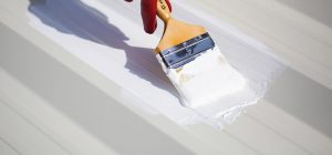 Applying waterproofing primer with brush
